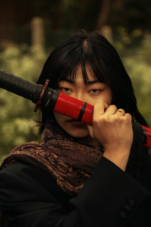 a girl is holding two red swords with their hands