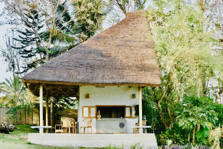 a white cottage sitting on top of a lush green field