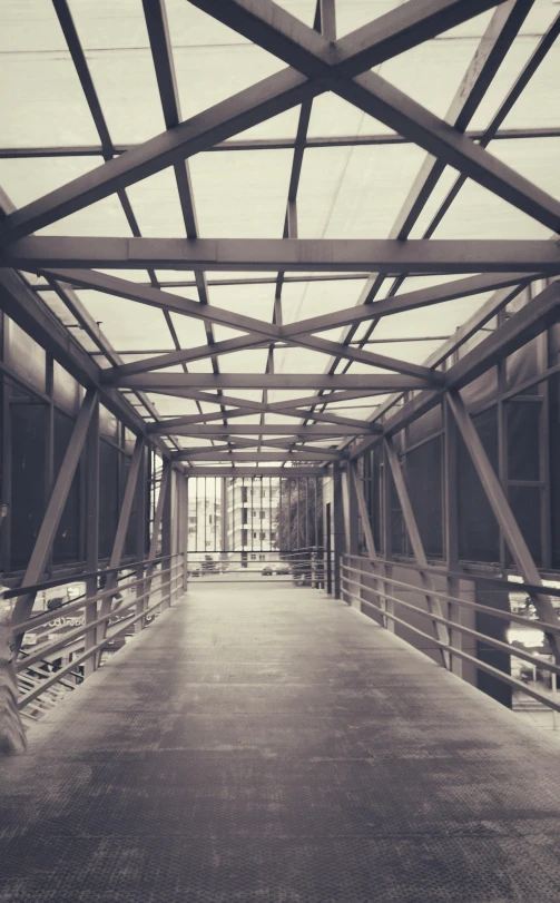 an empty corridor with benches and lights