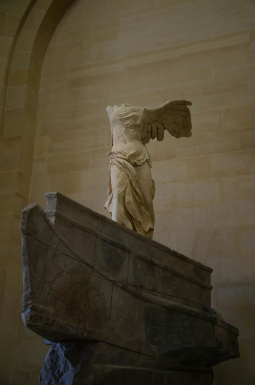 a statue of an angel with a large body