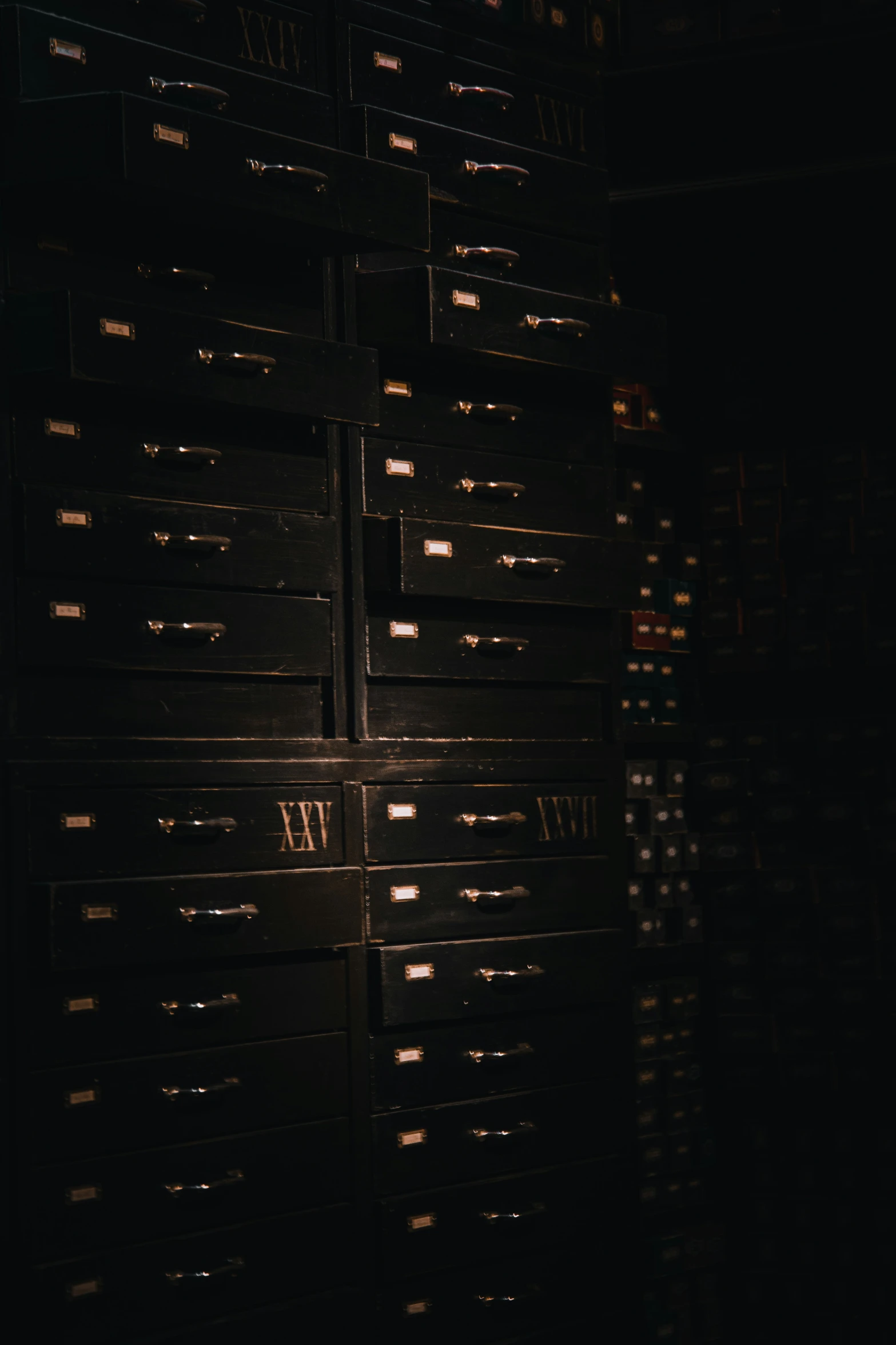 a black cabinet is shown with several drawers