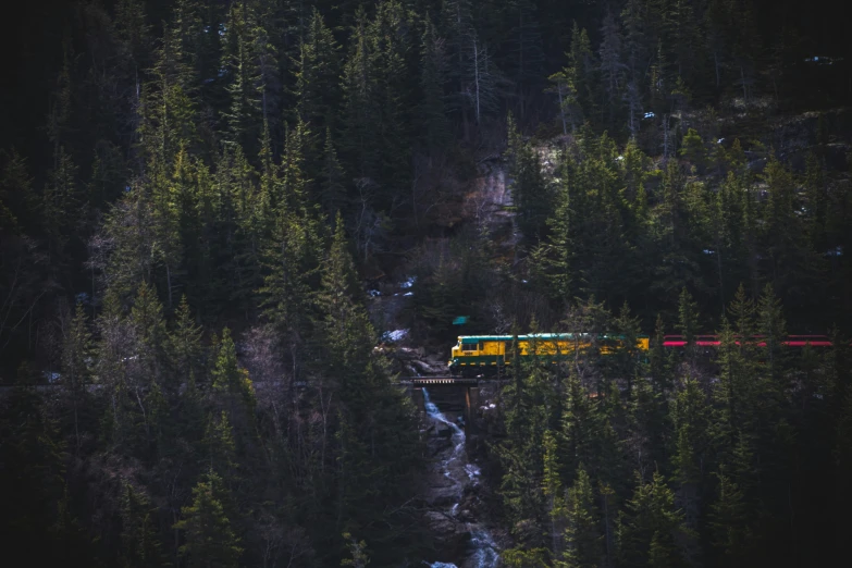 an aerial view of a train traveling along the tracks