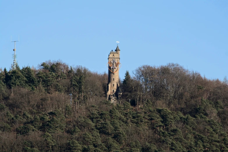 a tower that is standing on the side of a hill