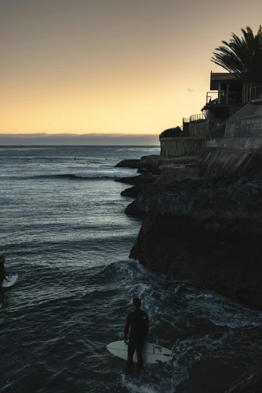 two surfers on the ocean at sunset