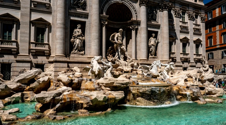 several fountains in front of buildings and trees