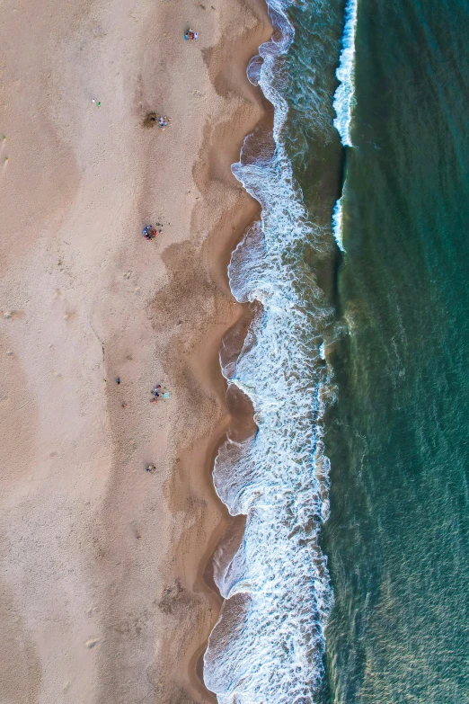 aerial s of a sandy beach with lots of ocean waves