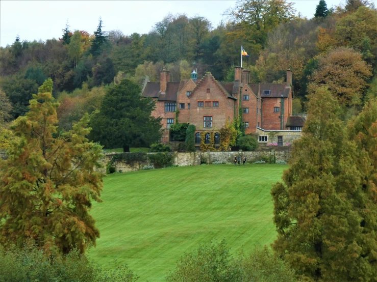 an old building in the background is surrounded by trees