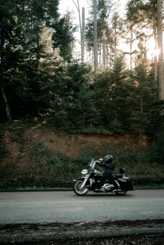 a man rides a motorcycle in the road