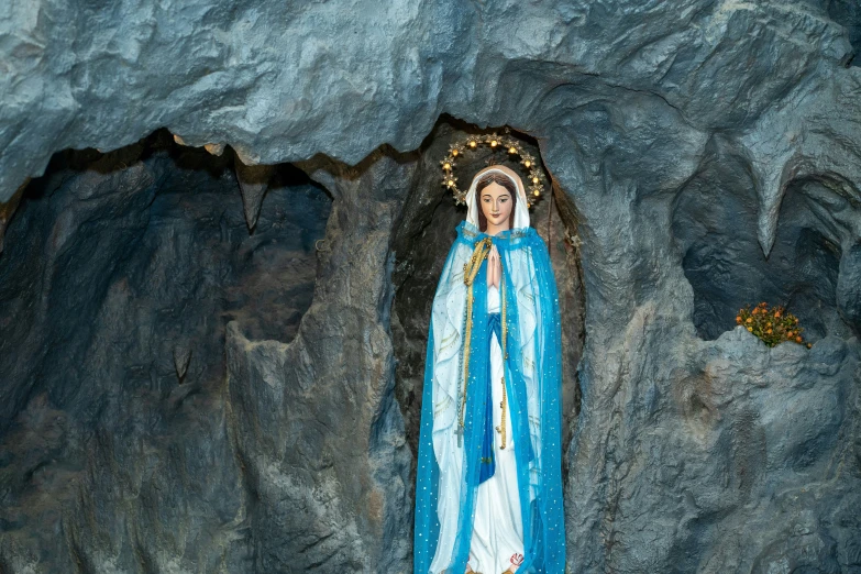 the statue is of the virgin mary inside the cave