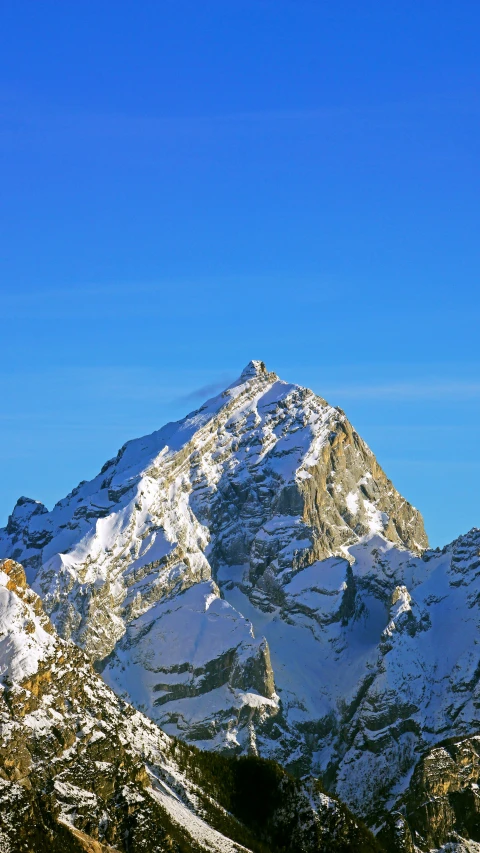 some snow covered mountains under a blue sky