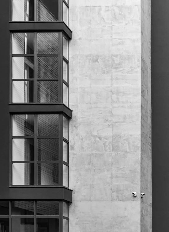 a person walks past a tall building near a window