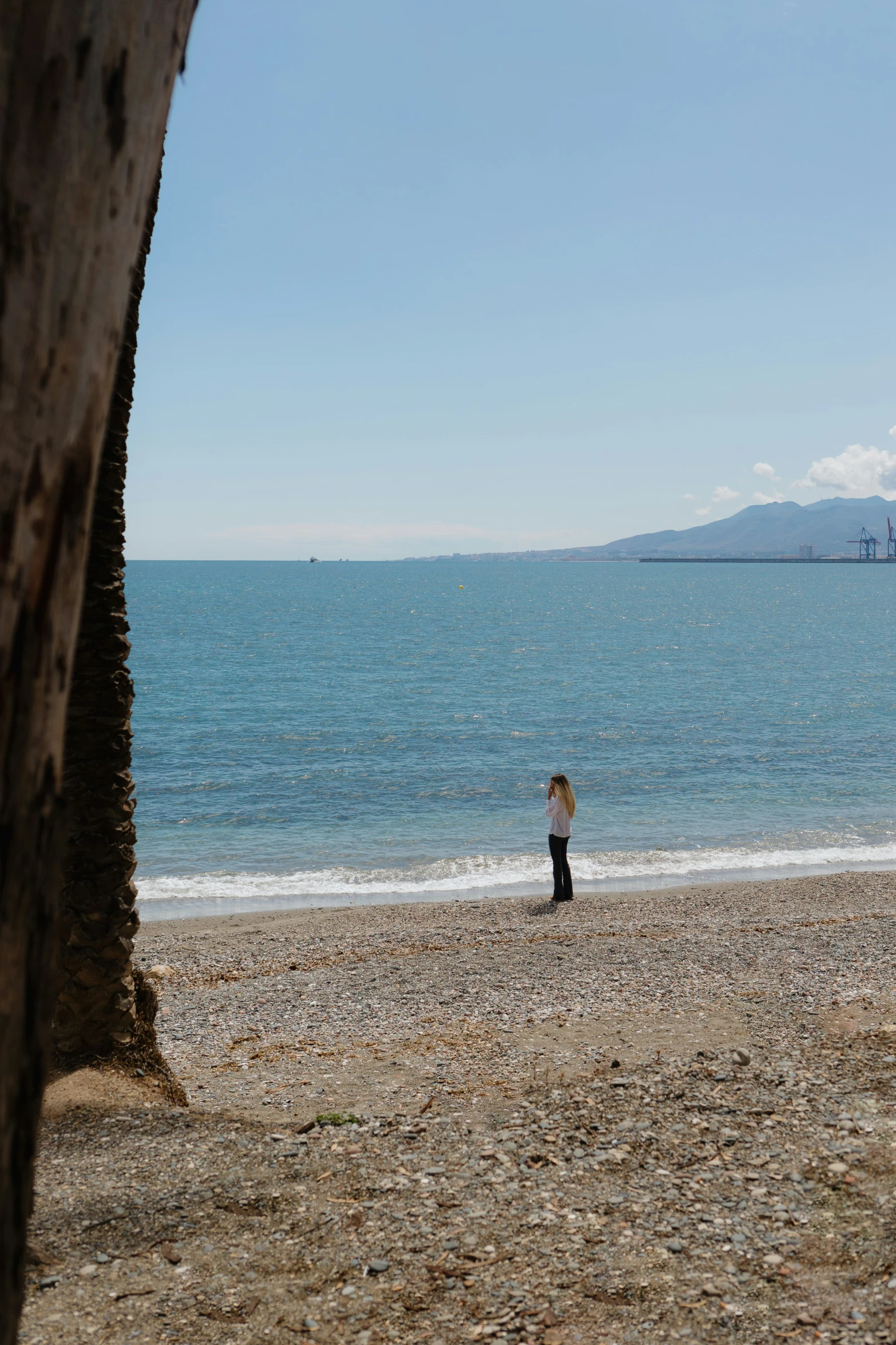 a man holding a surf board on the beach