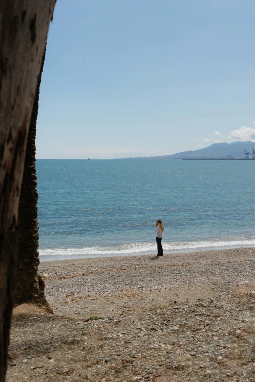 a man holding a surf board on the beach