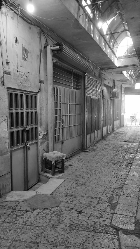 a dark hallway with windows that look out onto the street