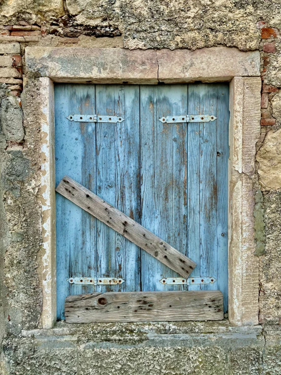 a blue door is in front of a stone wall