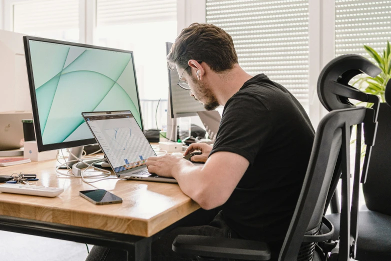 a man at his desk working on a computer