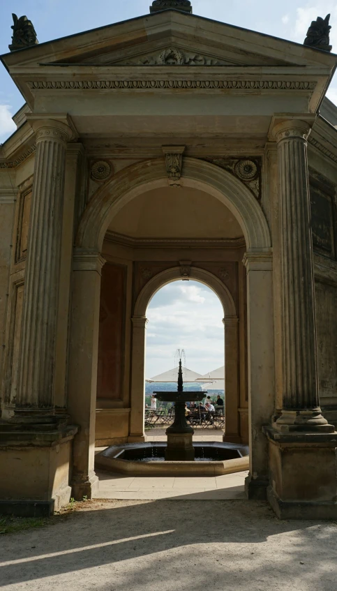 a large archway entrance with two statues on top of it