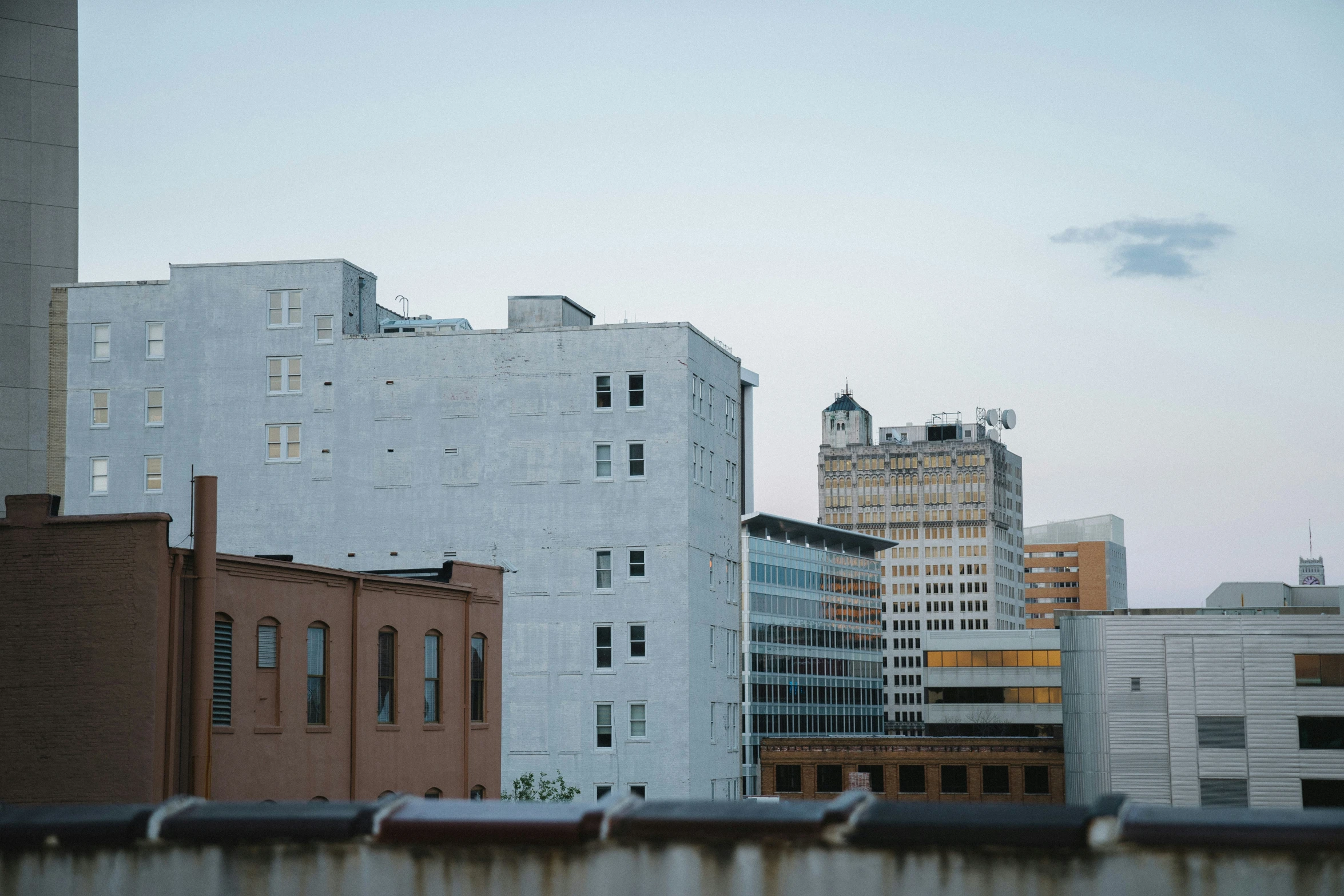 a tall white building sitting next to a river