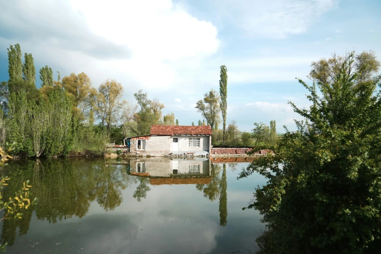 a house sitting on the edge of the river