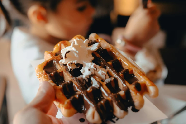 a close up of a waffle being held