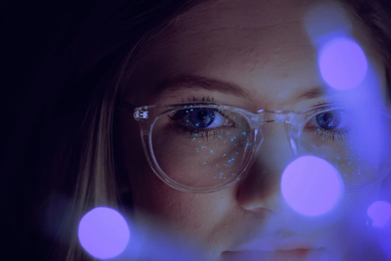 the woman is wearing glasses with blue lights
