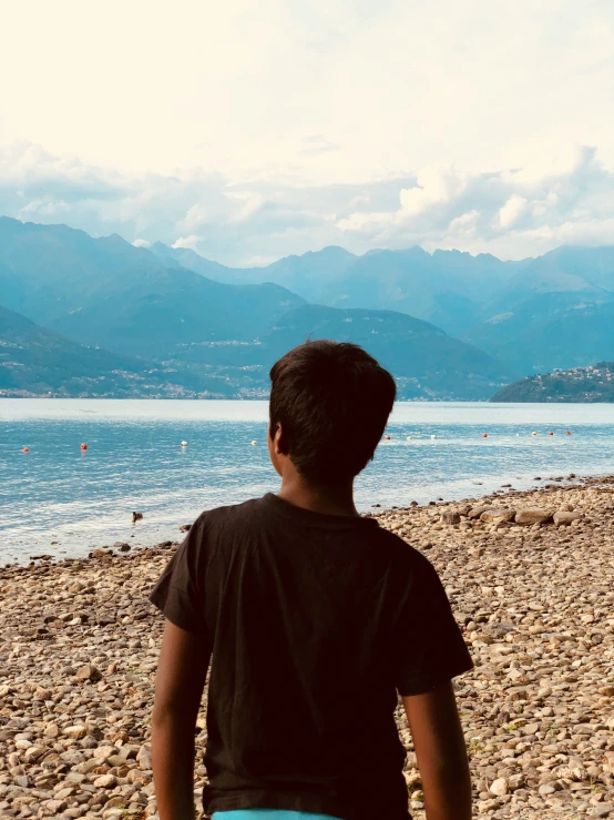 the young man watches boats on the ocean