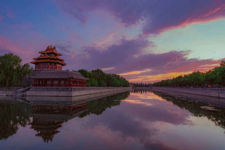 an old chinese pagoda sitting above a river