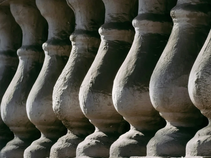 many vases lined up against the wall