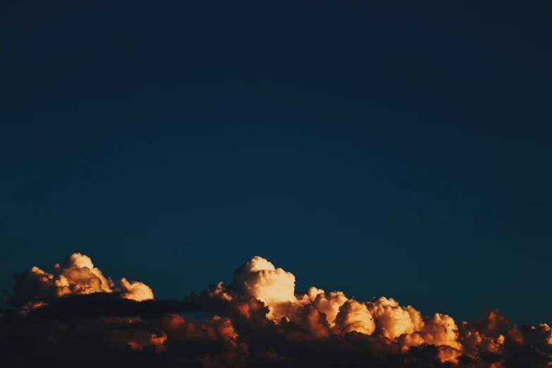 a large cloud of colorful clouds is visible on a blue sky