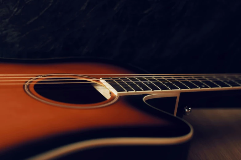 an acoustic guitar sits on top of a table