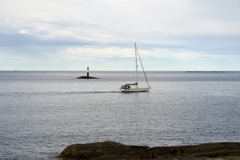 a sailboat traveling on a body of water