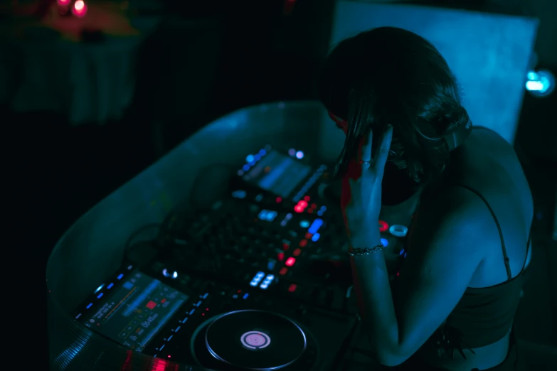 a girl is playing with the controller for a dj set