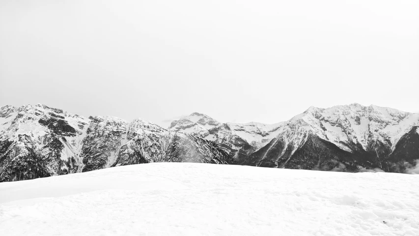 man riding skis down the side of a snow covered slope