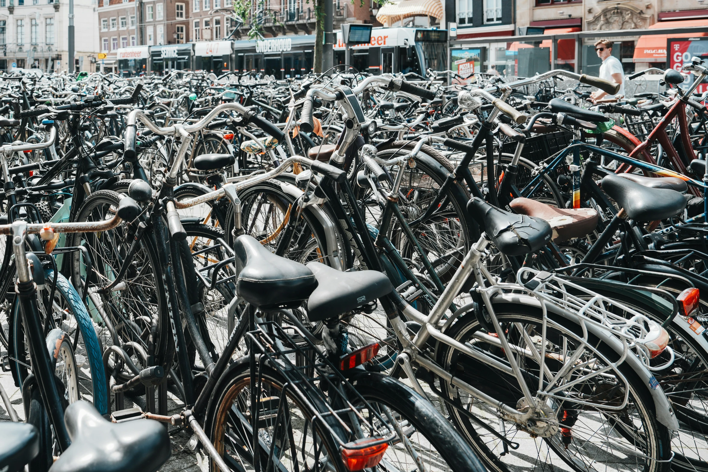 a large number of bikes parked next to each other in the city