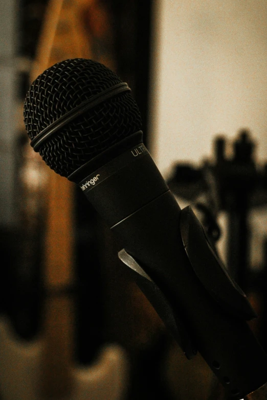 a microphone with a mic in front of a woman on a chair