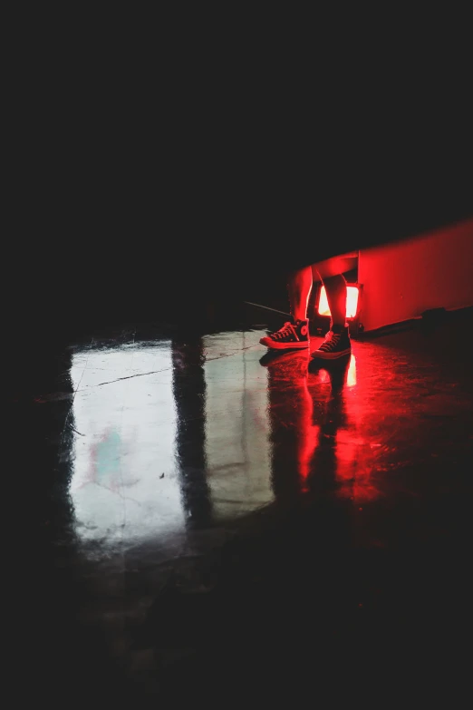 a skateboard laying against a wall at night