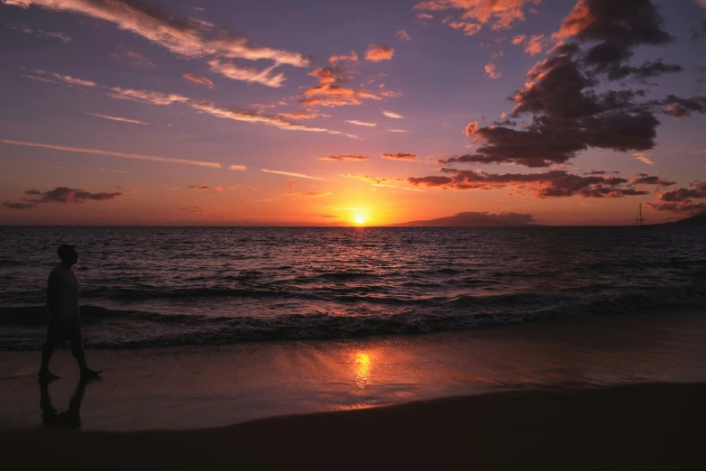 the sun sets over an ocean with calm waves