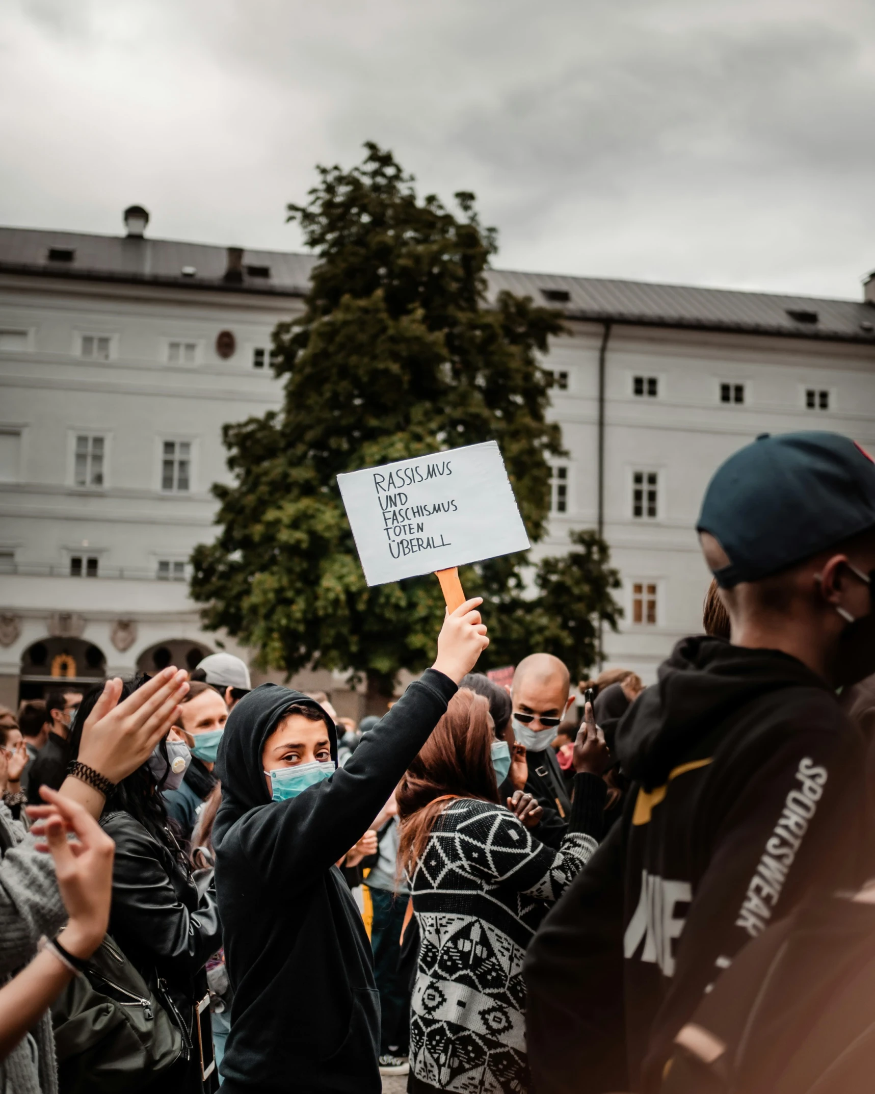 a group of people in a crowd with their hands up