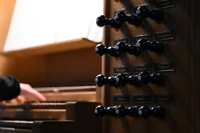 a person with their hand in front of a piano