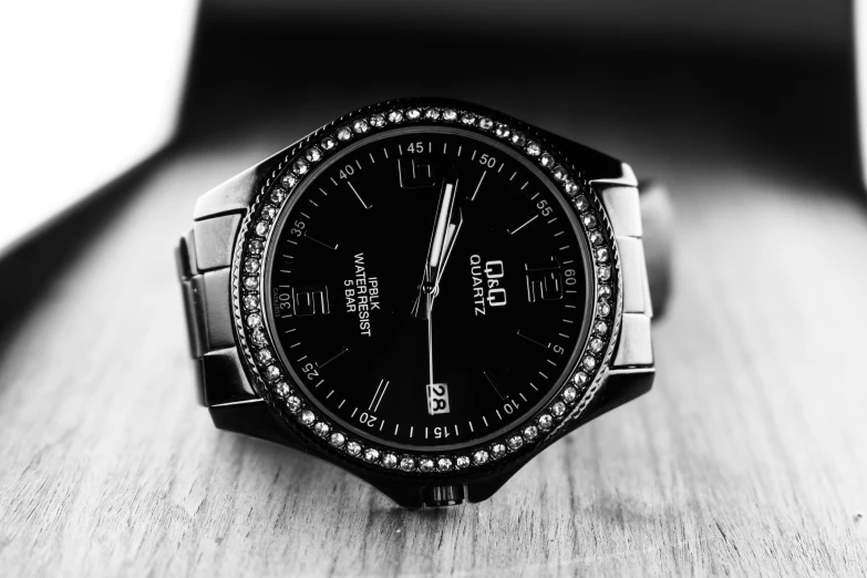 black and white po of a watch sitting on a table