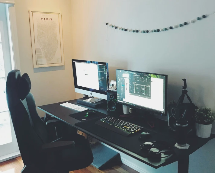 two computers are sitting on the table together