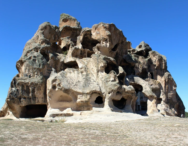 a large rocky cliff with some carved stone formations