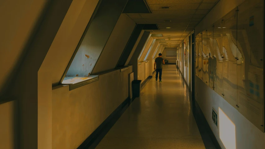 a man walks down the corridor between two walls