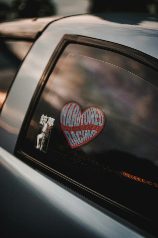 a car with a heart and sticker on it