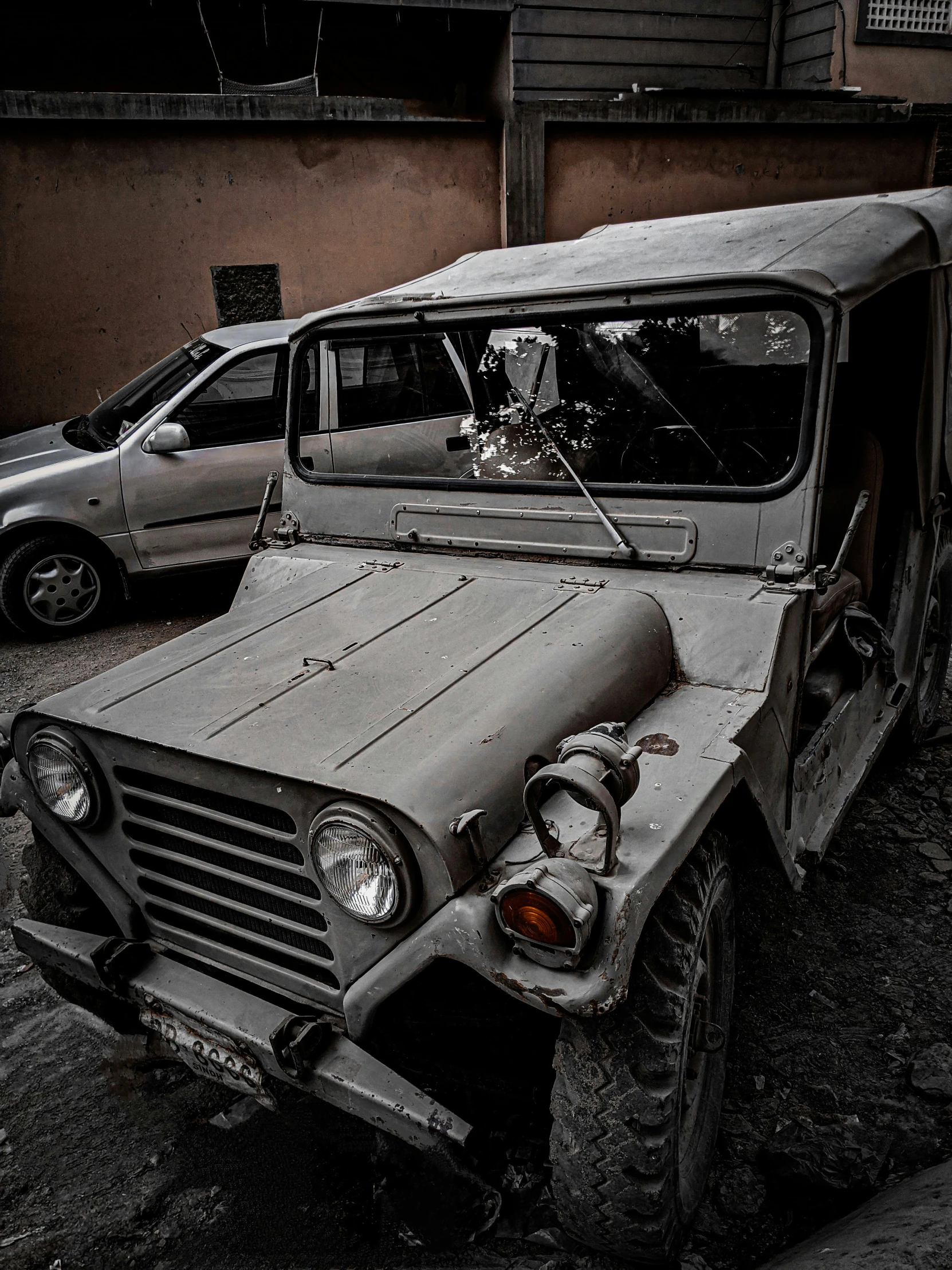 a broken up military truck parked next to a building