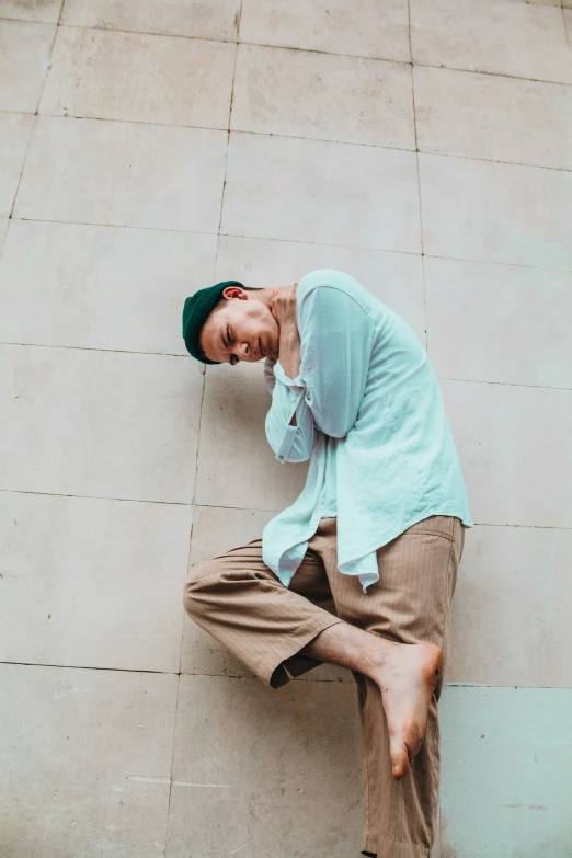 a man sitting on the floor with his foot in his face