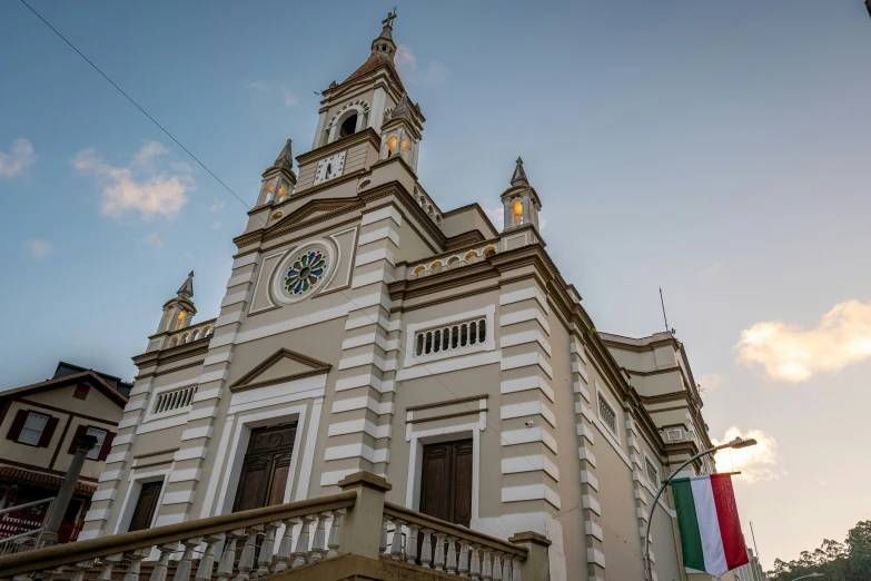 an ornate building with an american flag outside of it