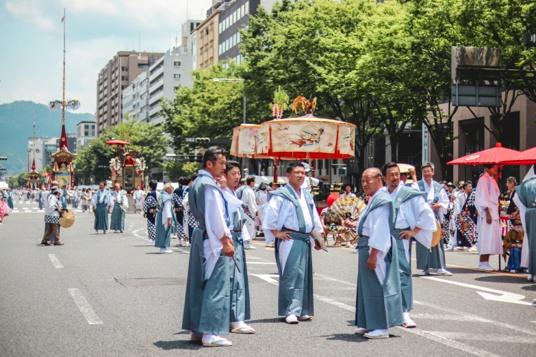 men walking in a parade while dressed in blue outfits