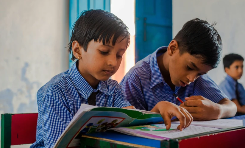 two school s are in uniform reading books