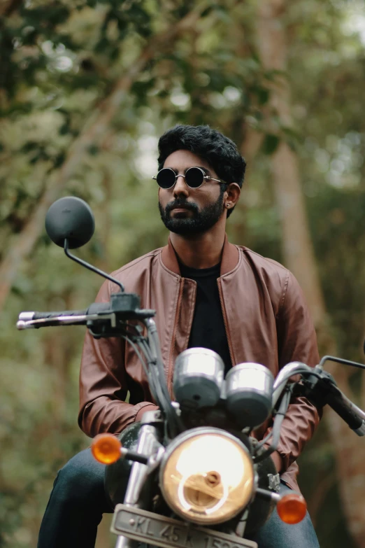 a man wearing sunglasses is riding a motorcycle